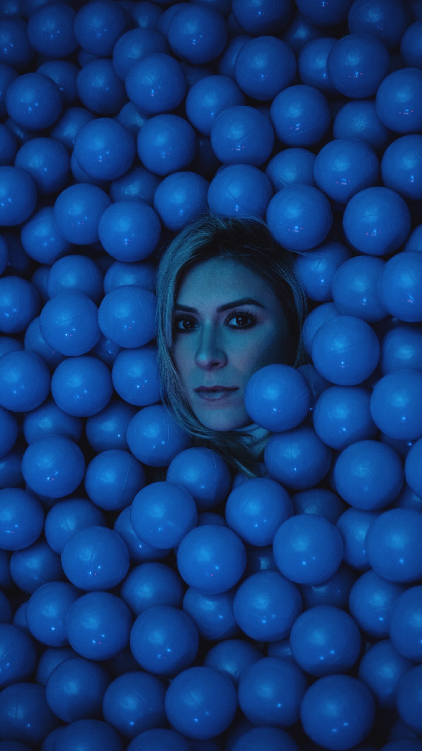 woman's face surrounded by blue balls